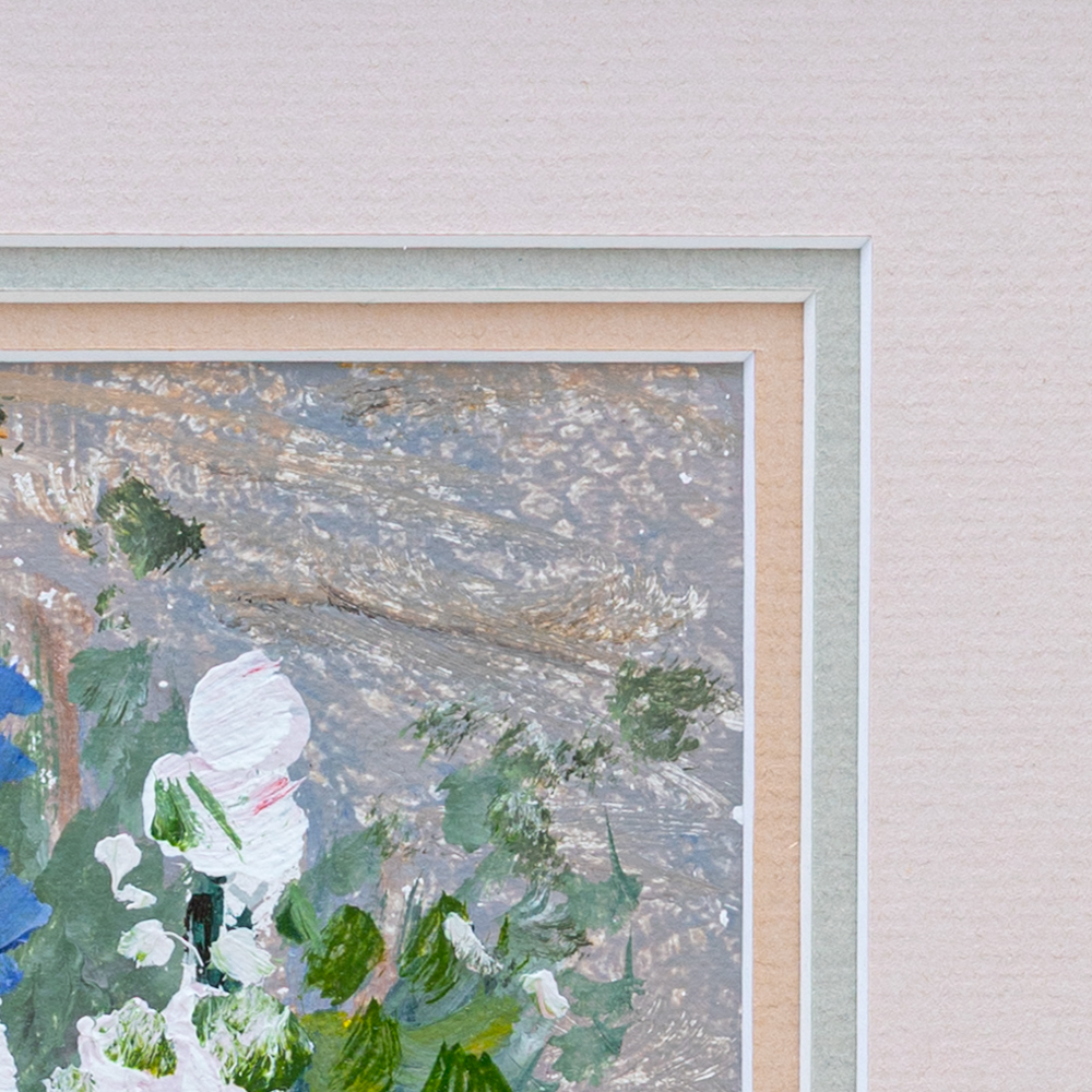 A close-up of a painting in a frame. The painting features white, green, and blue flowers on a textured background. The pa...